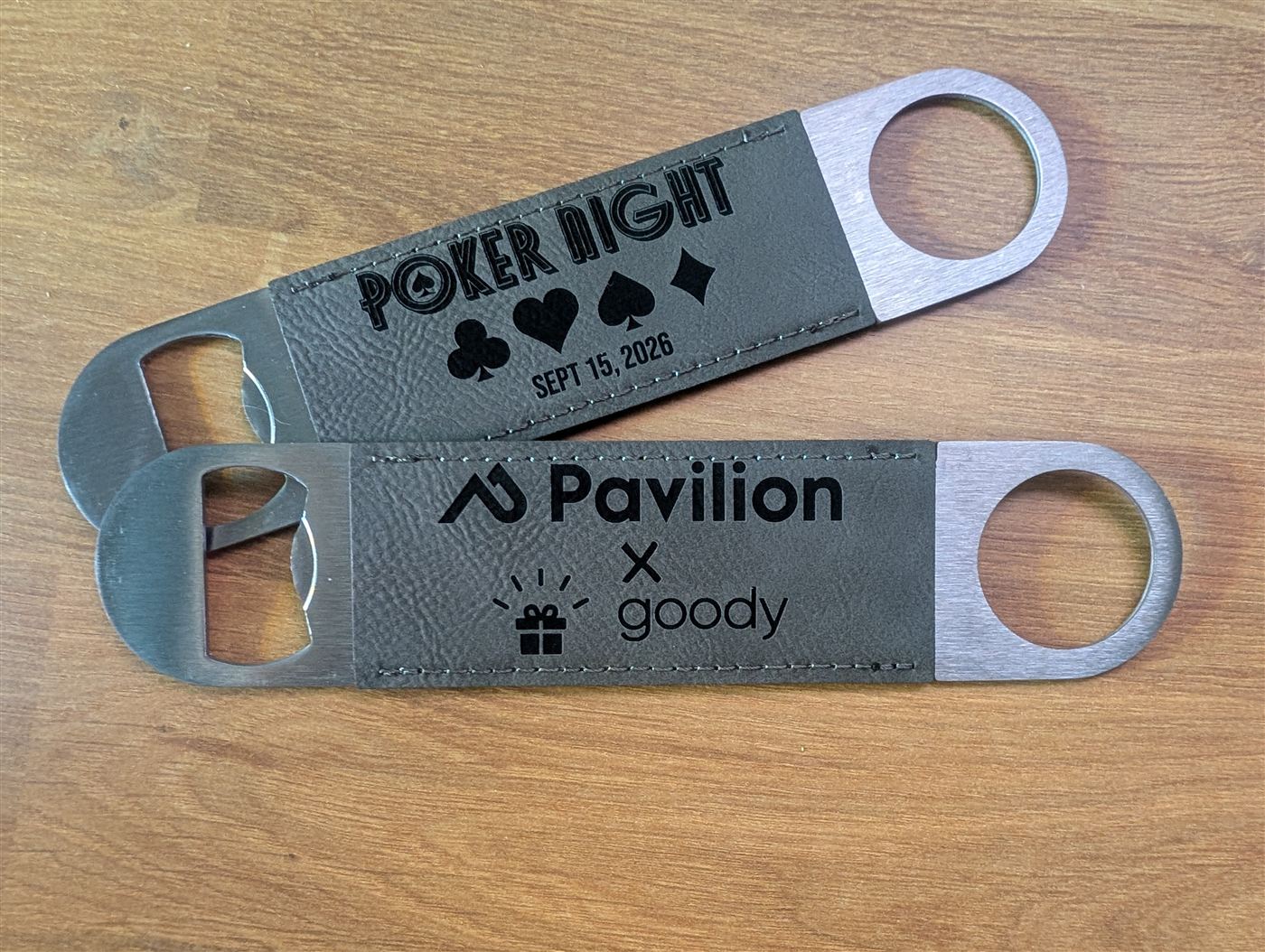 Leather-wrapped bottle openers engraved with an event logo and a poker night design
